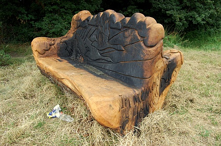 A fire-damaged carved wooden seat on Jubilee Green, Bradley Stoke.