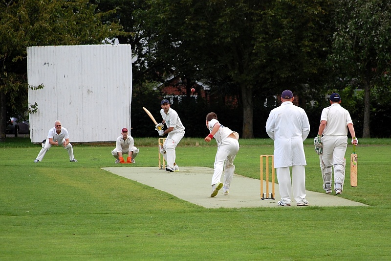 Cricket match in progress on an artificial wicket at Baileys Court, Bradley Stoke.