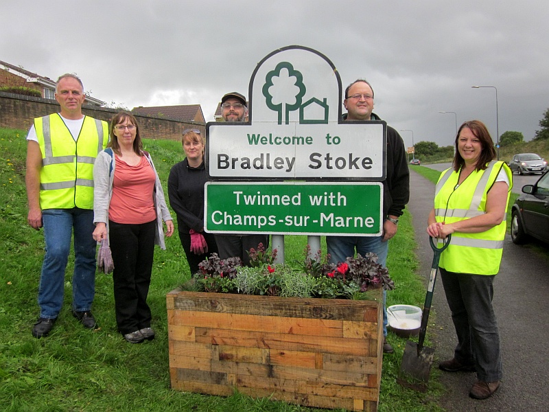 Bradley Stoke in Bloom group members install a planter on Bradley Stoke Way.