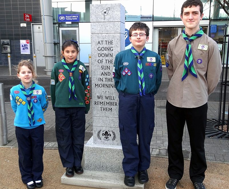 Scout group members beside the newly-installed war memorial in the town square.