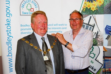 Cllr John Ashe receives the chain of office from the outgoing Mayor.