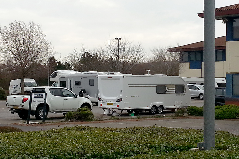Traveller vehicles in the car park of Kerry Group, Great Park Road, Bradley Stoke, Bristol.