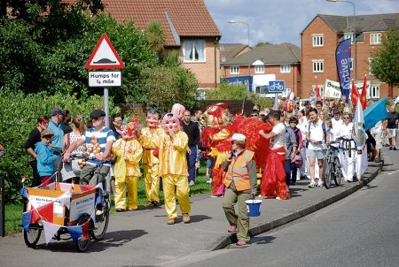 The 2014 Bradley Stoke Carnival parade approaches Manor Farm Roundabout.
