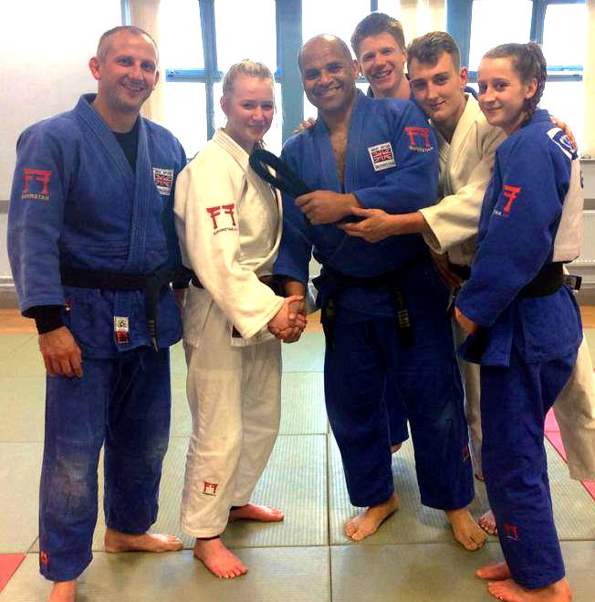 Bradley Stoke Judo Club's Eleanor Young (2nd from left) is presented with her black belt.