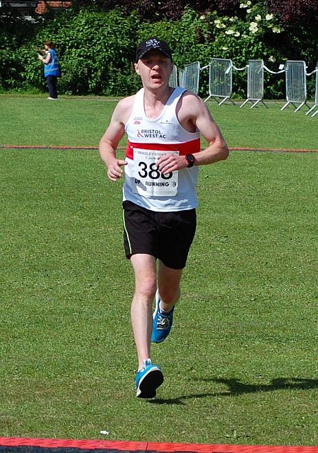 Ciaran McQuade crosses the finish line in the Bradley Stoke 10k Run 2015.