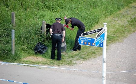 Police search a litter bin in the Three Brooks Local Nature Reserve, Bradley Stoke.