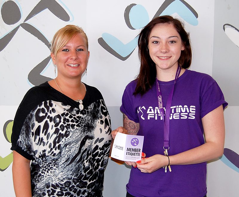 Prize draw winner Natasha Thwaites (left) receives her membership card from Chloe Depledge, club manager at Anytime Fitness Bradley Stoke.