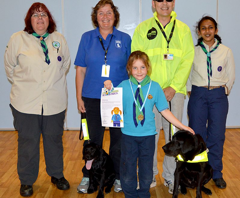 Jemima Grinter (centre) with (l-r) Donna Carl (assistant Beaver Scout leader), Annette Tadman (puppy walker for Guide Dogs, with Guilda), John Tovey (with Dez) and Beena Chheda (Beaver Scout leader).