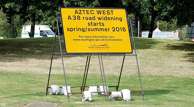Sign advertising consultation on a road widening scheme at the Aztec West Roundabout.