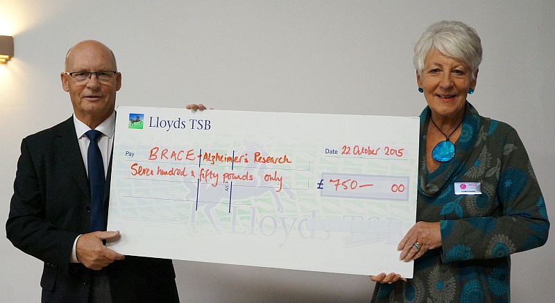 Isobel Gelder, of dementia research charity BRACE, receiving a cheque for £750 from Bradley Stoke Cricket Club captain George Eland.