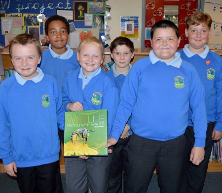 British Wildlife Photography Awards 2015 - Meadowbrook Primary School Year 6 pupils with a copy of the hardback book that includes their winning photographs.