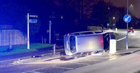 A vehicle lies on its side on Brook Way, Bradley Stoke, after apparently striking a traffic island that separates a cycle lane from the main carriageway, in the vicinity of a speed cushion an informal pedestrian crossing.