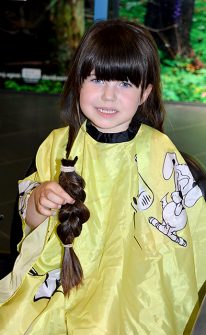 Lily Williams has her long hair cut off for donation to the Little Princess Trust.