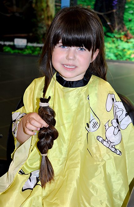 Lily Williams has her long hair cut off for donation to the Little Princess Trust.