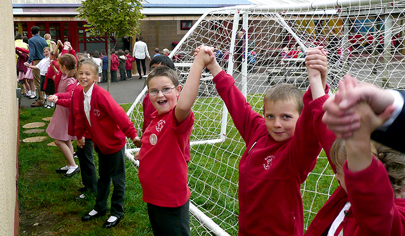 Celebrations to mark the 20th anniversary of Baileys Court Primary School: Building hug.