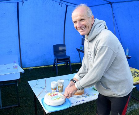 Richard Nuell cuts a celebratory cake after completing his 100th half marathon. Richard reached his record by completing the Stroud Half Marathon on 23rd October 2016.