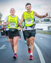 Blind runner Chris Blackabee competing in the 2016 Budapest Marathon with his guide Colin Johnson.