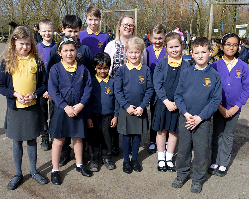Photo of pupils and headteacher at Wheatfield Primary School.