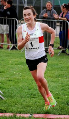 Helen Newberry takes the final turn to win the female category in a time of 37:00.