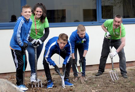 Volunteers from Boeing Defence working with students at Bradley Stoke Community School on a World Earth Day project.