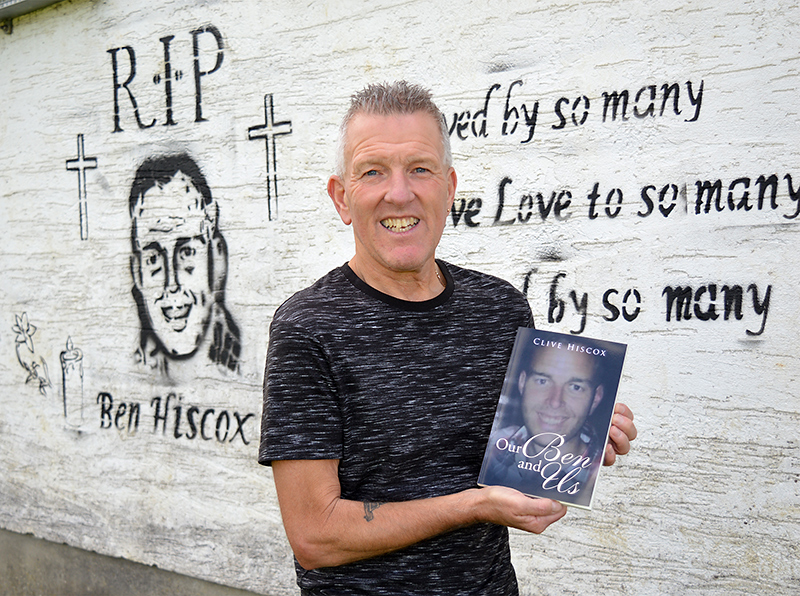 Photo of Clive Hiscox with a copy of the book he has written.