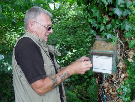 Photo of Colin Davies repairing a dormouse box .