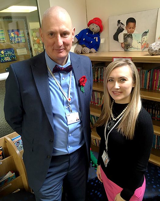 Photo of Dave Baker with Amelia Newport at Charborough Road Primary School.