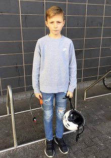 Photo of Josh Harding holding a bike helmet and bike lock.