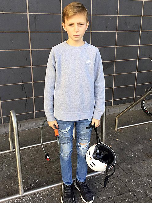 Photo of Josh Harding holding a bike helmet and bike lock.