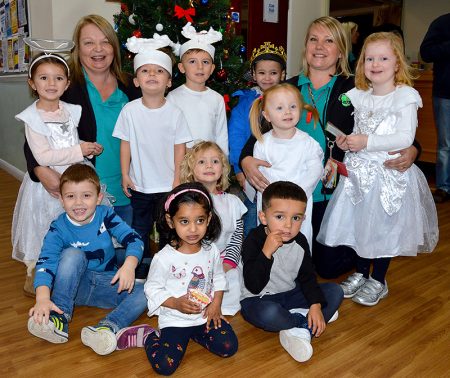 Photo of Noleen Clarke (3rd from left) and Natalie Robbins and some of the children.