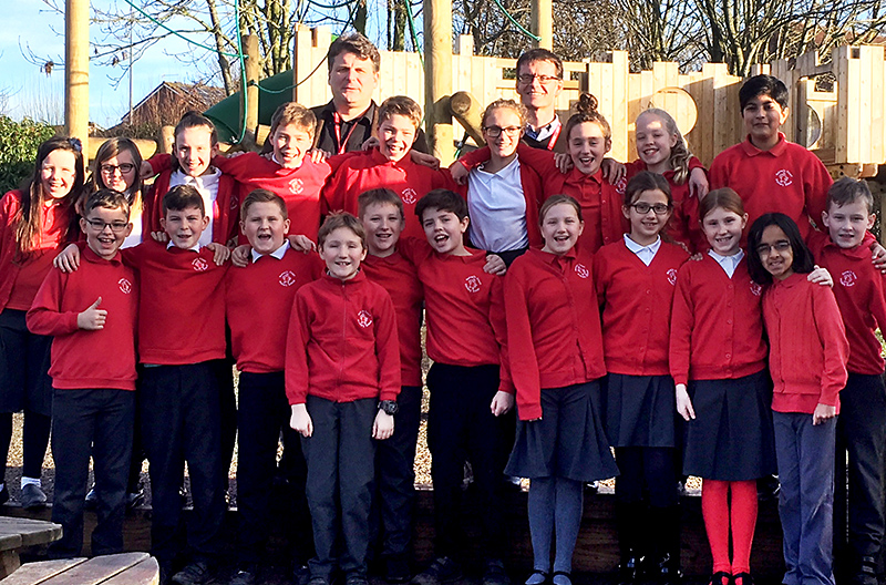 Photo of pupils and staff celebrating the school's recent 'good' report.