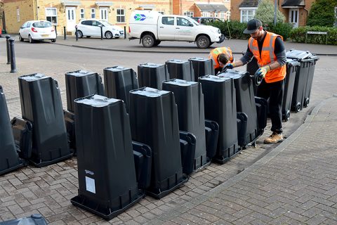 Photos of new, smaller black bins lined up on a street in Bradley Stoke.