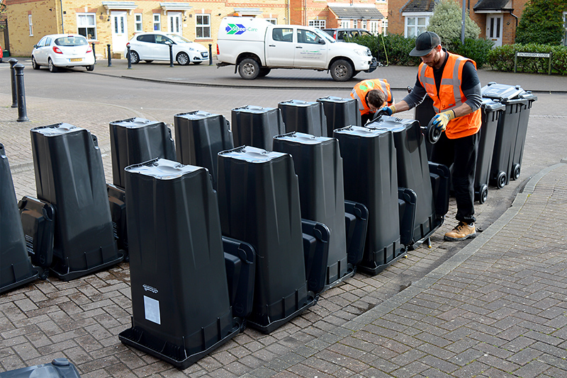 Photos of new, smaller black bins lined up on a street in Bradley Stoke.