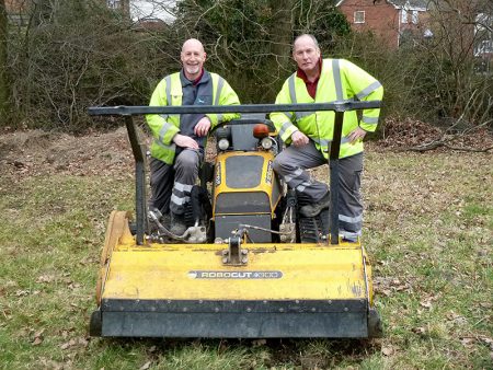 Photo of volunteers with a Robocut machine brought in to clear scrub.