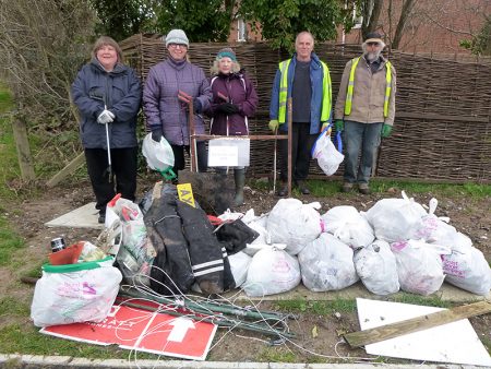 Photo of BSiB volunteers standing behind an assortment of rubbish that they collected during their Big Spring Clean.