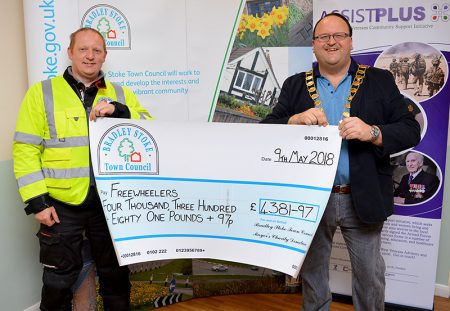 Photo of Cllr Andy Ward presenting a charity cheque to Matt Eager, fundraiser and rider for Freewheelers EVS.
