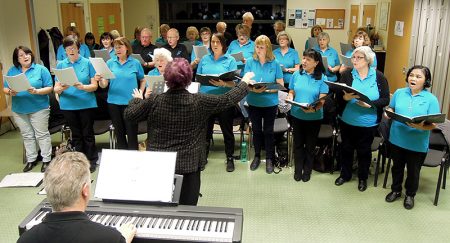 Photo of Stokes Singers in rehearsal for their 25th anniversary concert.