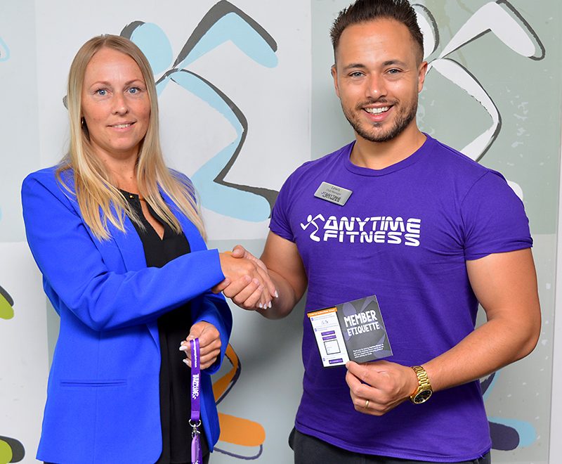 Photo of Kasia Bedkowska receiving her membership key from Lewis Erskine, club manager at Anytime Fitness Bradley Stoke.