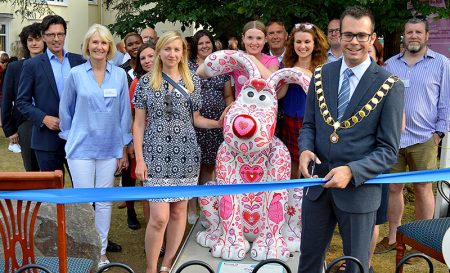 Photo of Bradley Stoke mayor Ben Randles officially 'opening' the Cupid sculpture.