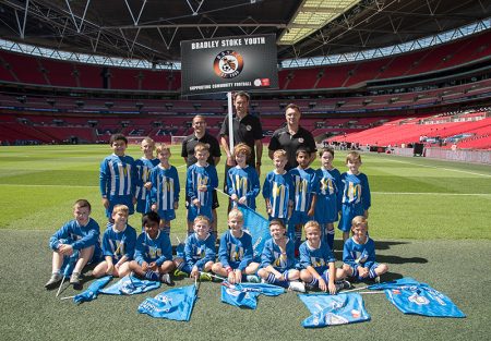 Coaches and players of BSYFC U8 Whites pictured at Wembley Stadium prior to performing their pre-match duties