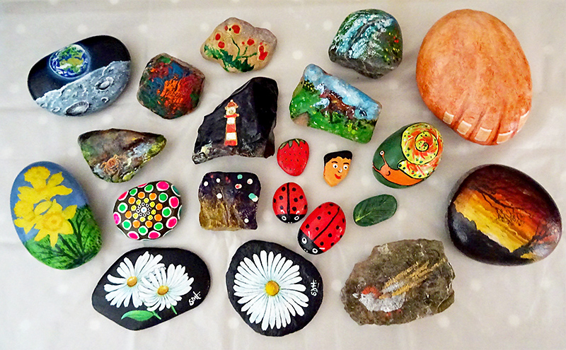 Photo showing a selection of pebbles painted by Stokes Art Group.