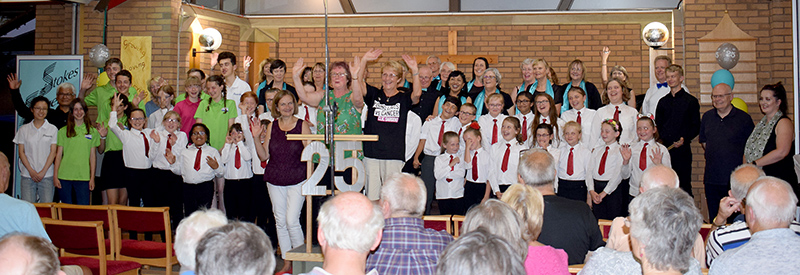 Photo of performers at the end of the Stokes Singers summer concert.