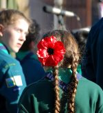 Photo of a poppy in a Scout's hair at the Remembrance ceremony.