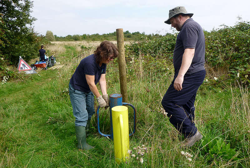 Photo of conservation group volunteers installing wooden posts on the Tump.