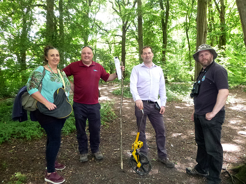 Photo of volunteers from the conservation group planning and marking the route of the new woodland paths.