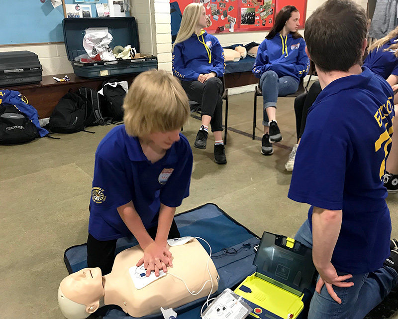 Photo of two Scouts practising CPR on a dummy.