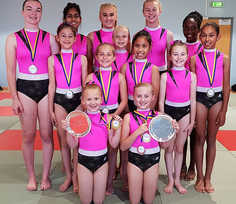 Photo of club members with medals and trophies won at the 2019 South West Championships.