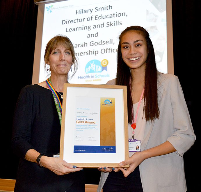 Photo of Jemina Paramore accepting the 'Health in Schools' Gold Award from Sarah Godsell.