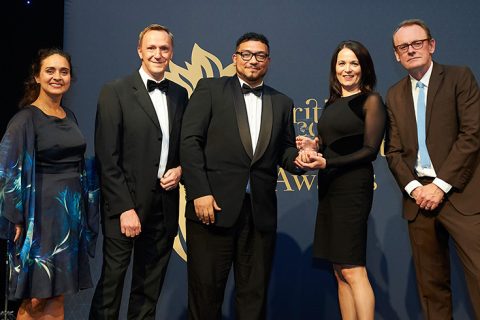 Photo of Natasha Miller (left), Matthew Dobbins (2nd from left) and Lisa White (2nd from right) receiving the award, in the presence of TV comedian Sean Lock (right).