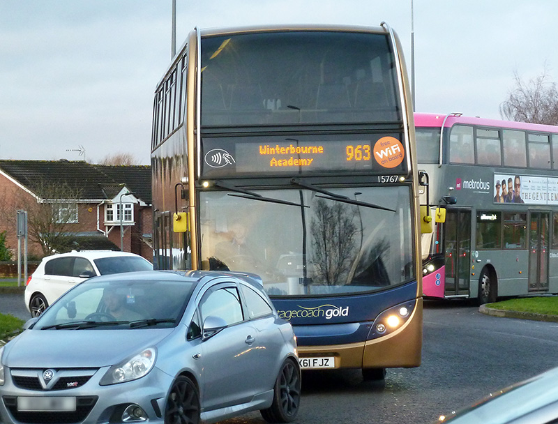Photo of a 963 Winterbourne Academy school bus service vehicle stuck in traffic congestion at Great Meadow Roundabout.